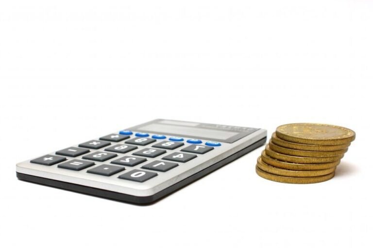 calculatrice avec pieces de monnaie empilees