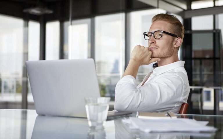 homme reflechissant devant plusieurs contrats dassurance