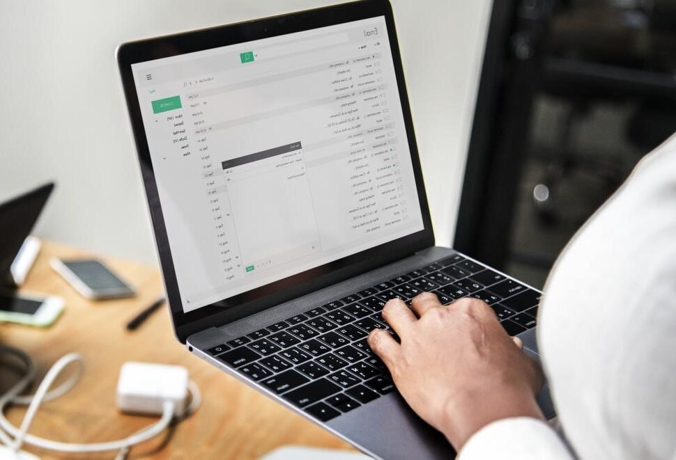 personne envoyant un email sur ordinateur portable