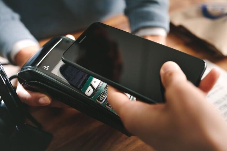 Comment Retirer De L'Argent Avec Son Téléphone Sans Carte Bancaire 1 personne utilisant smartphone pour paiement mobile